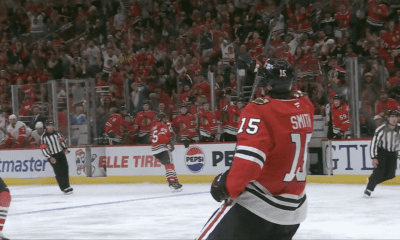 Craig Smith #15 celebrates after scoring off his own rebound to tie the Chicago Blackhawks and Detroit Red Wings at 1 on Sept. 25.