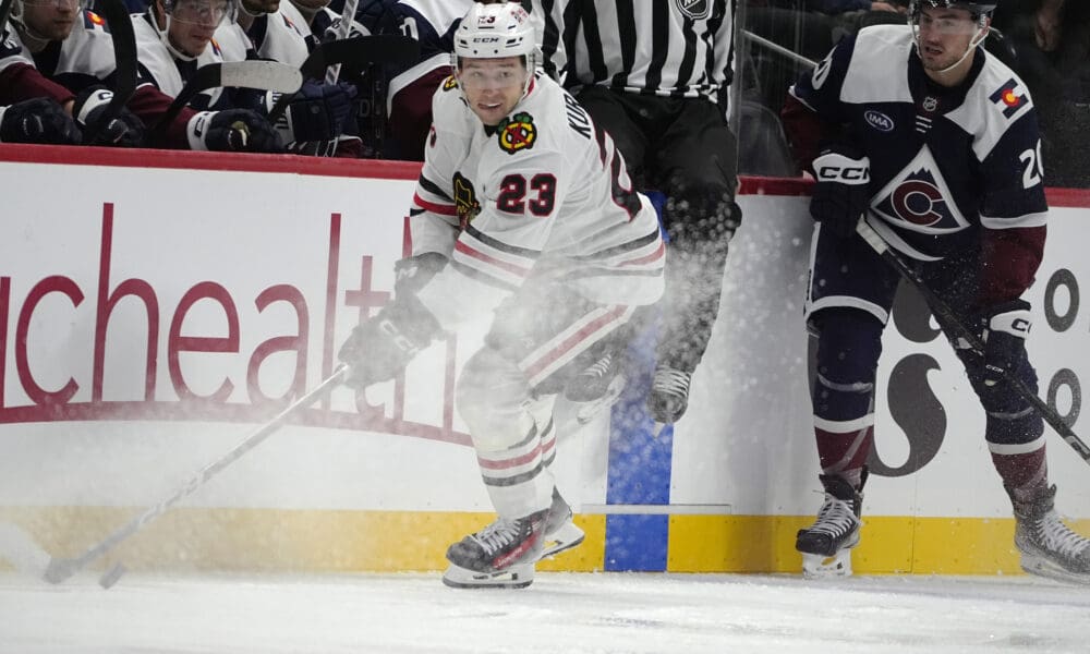 Chicago Blackhawks center Philipp Kurashev, left, collects the puck as Colorado Avalanche center Ross Colton pursues in the second period of an NHL hockey game Monday, Oct. 28, 2024, in Denver. (AP Photo/David Zalubowski)